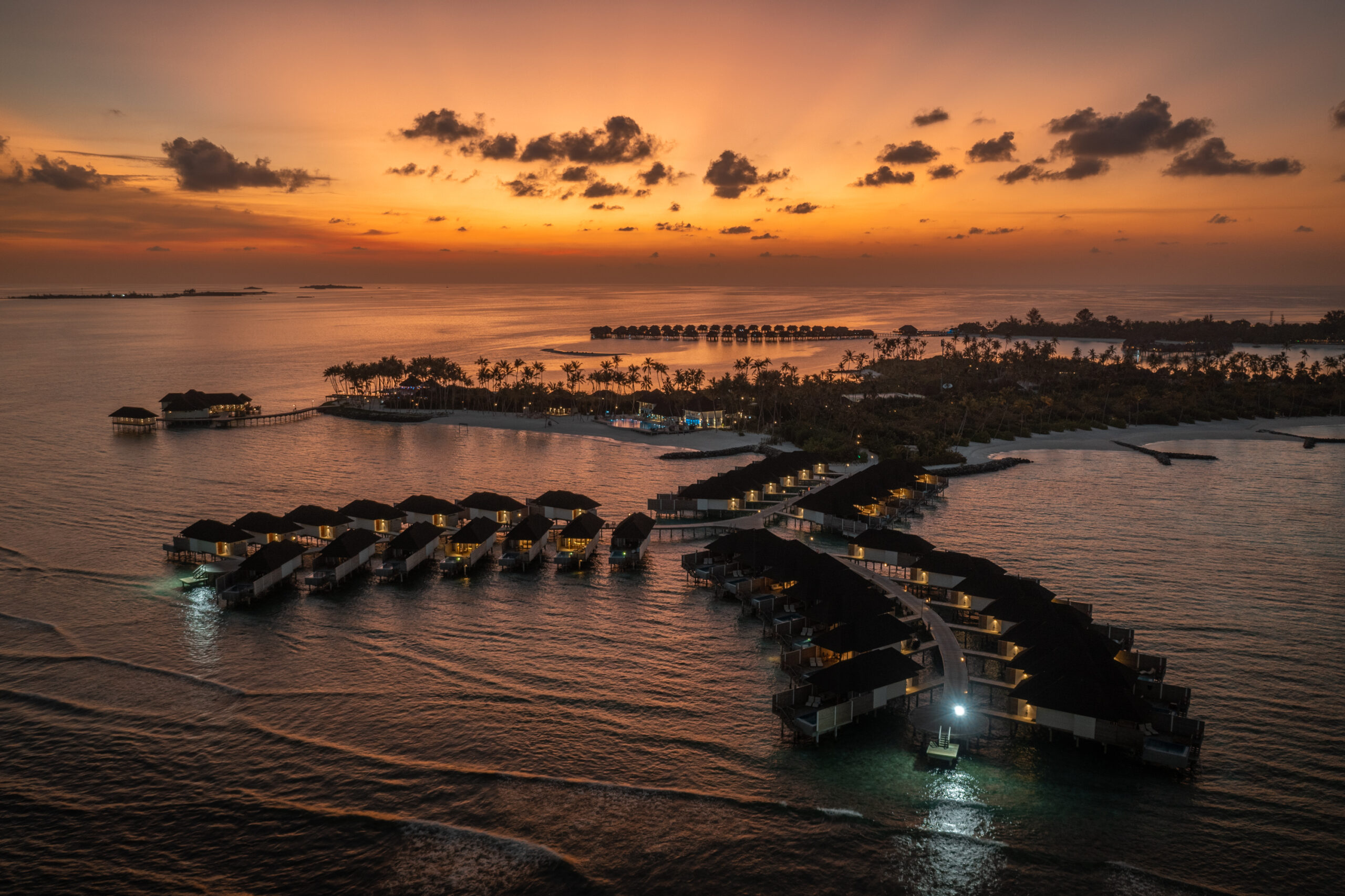 Maldives resort and water villas at sunset